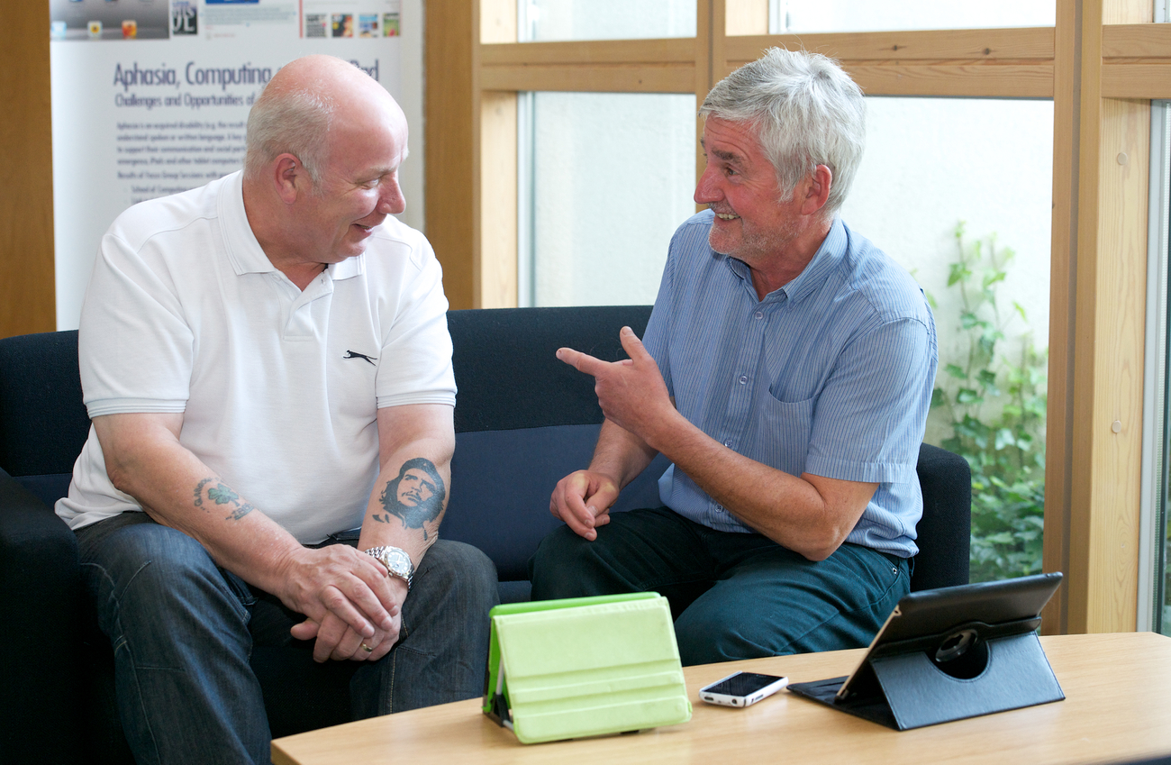 Eddie (right) and another person with aphasia with their ipads